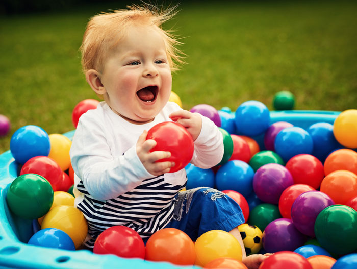Baby playing with colourful balls